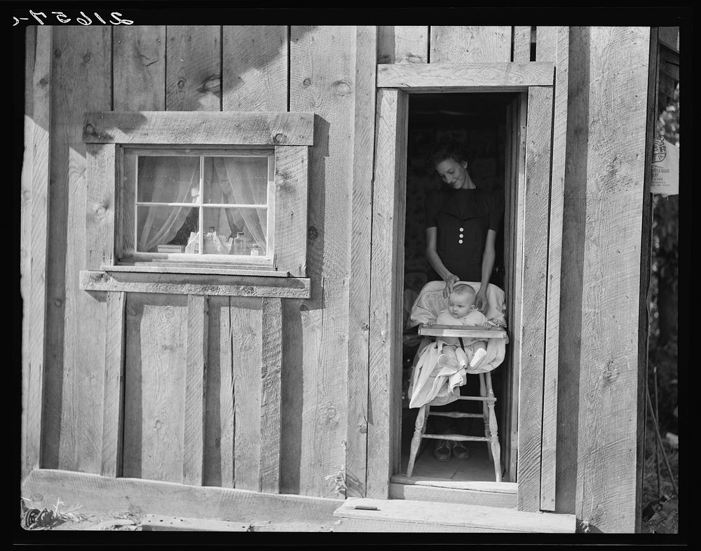 Wife and baby of president of Ola self-help sawmill co-op in doorway of their home. Gem County, Idaho. General caption 48.…