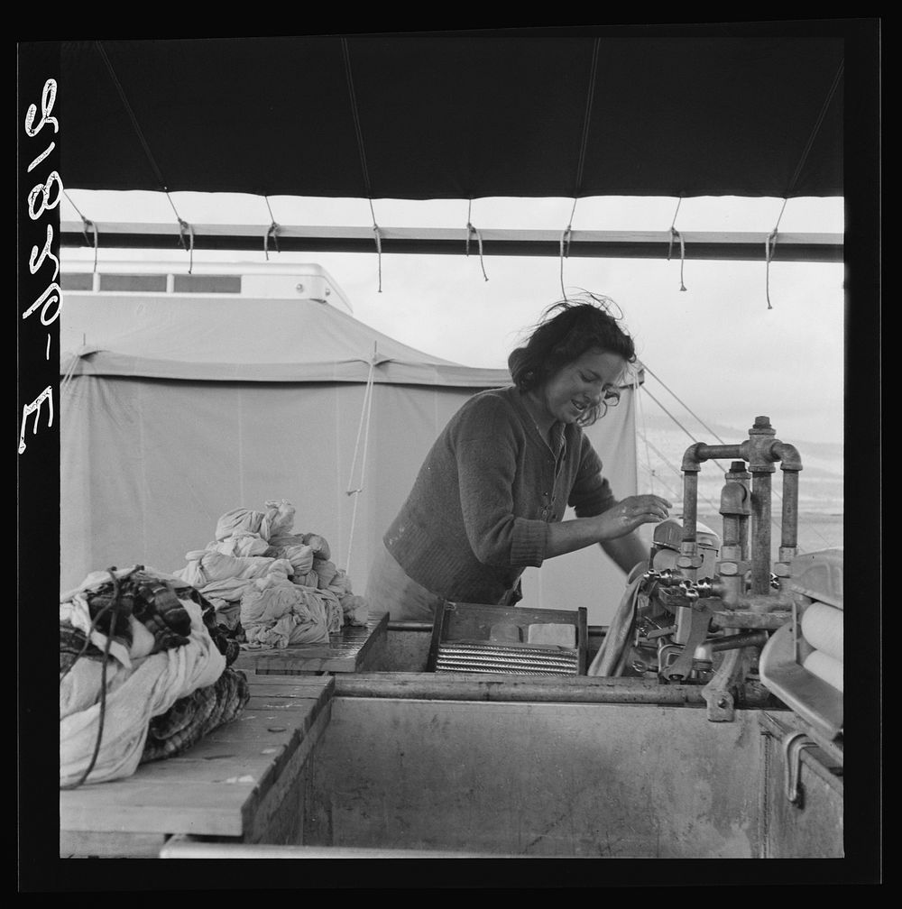 Young migrant girl makes use of facilities provided for cleanliness. Merrill FSA (Farm Security Administration) camp…