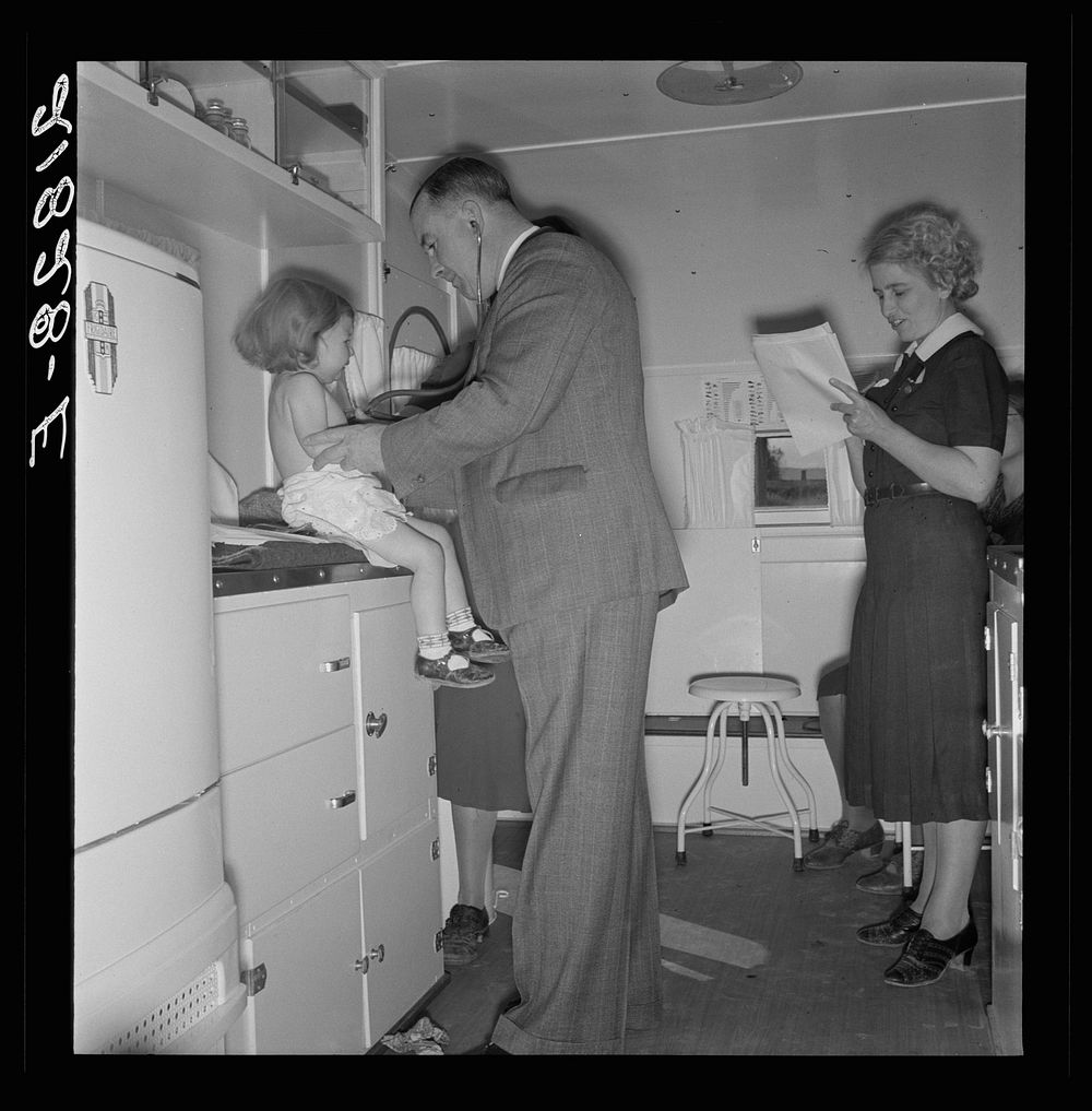 [Untitled photo, possibly related to: Doctor examining children in trailer clinic. FSA (Farm Security Administration) mobile…