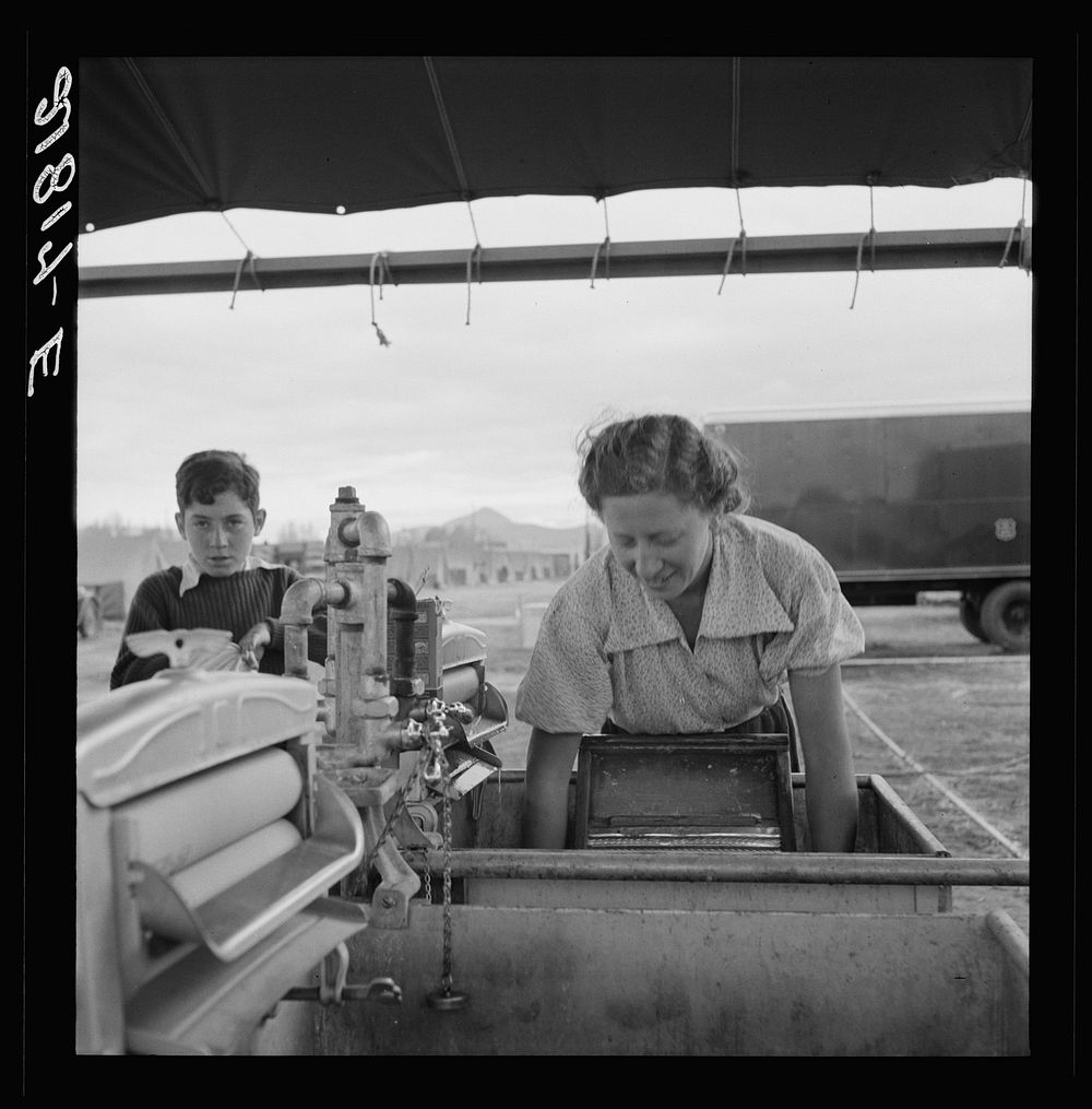 [Untitled photo, possibly related to: Portable laundry unit, shower unit beyond. FSA (Farm Security Administration) camp…
