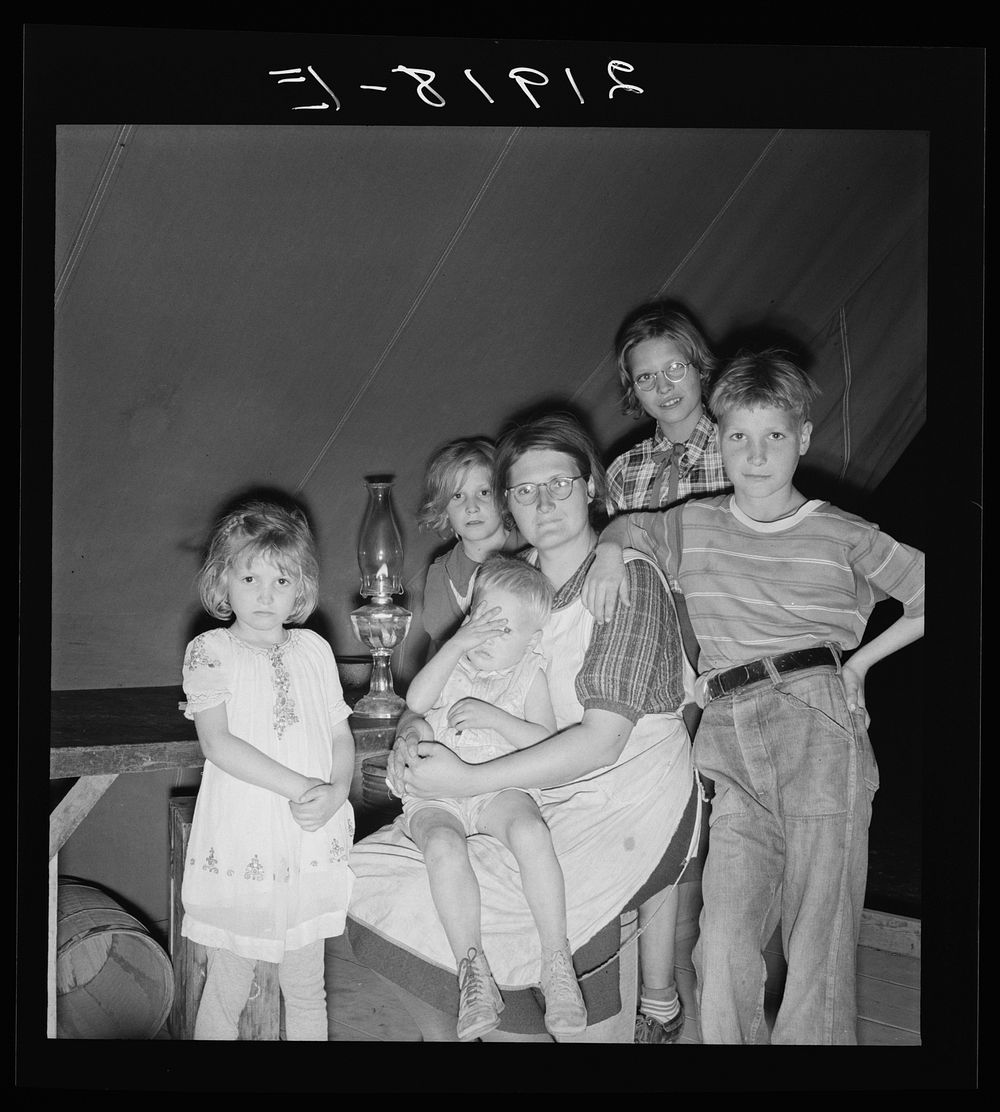 [Untitled photo, possibly related to: Family of six in tent after supper. Came to potato harvest after father was laid off…