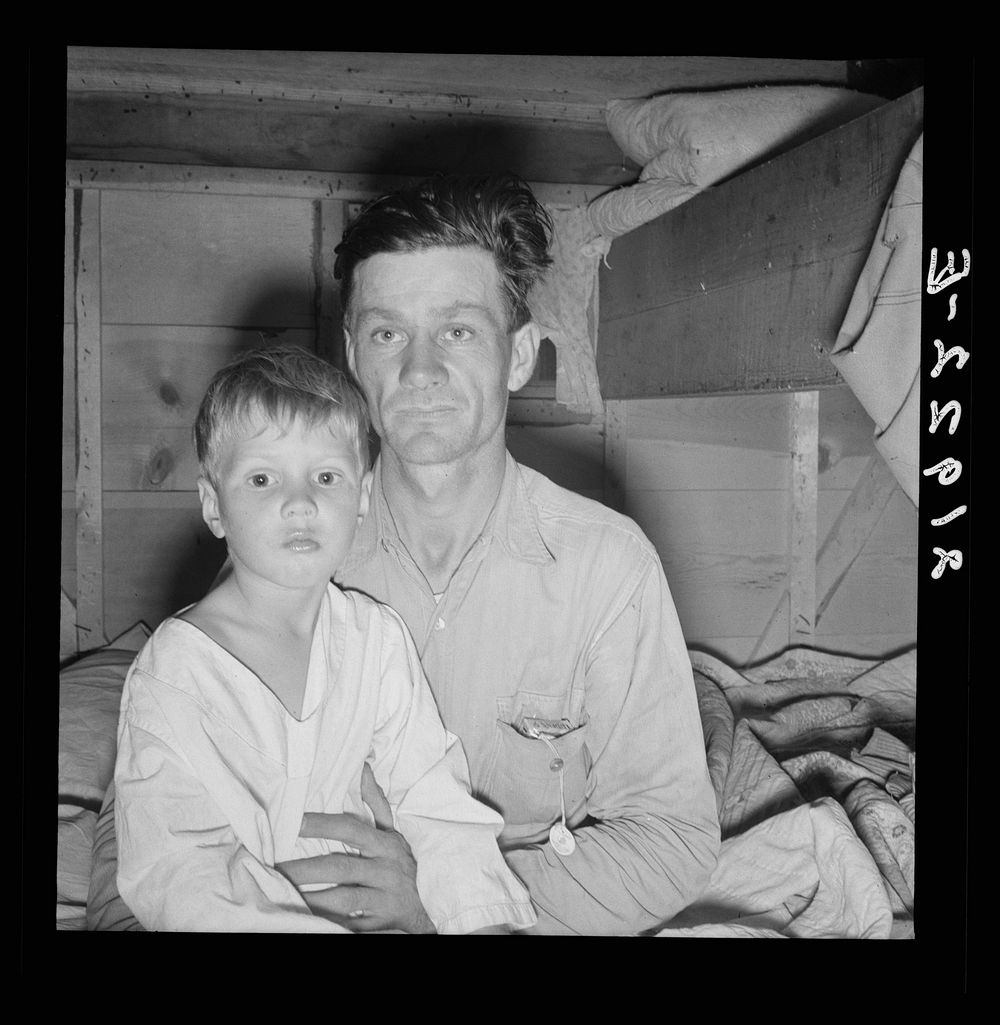 He brought his family to the west in a homemade trailer from Texas five months ago. Photograph made after supper. Boy sick.…