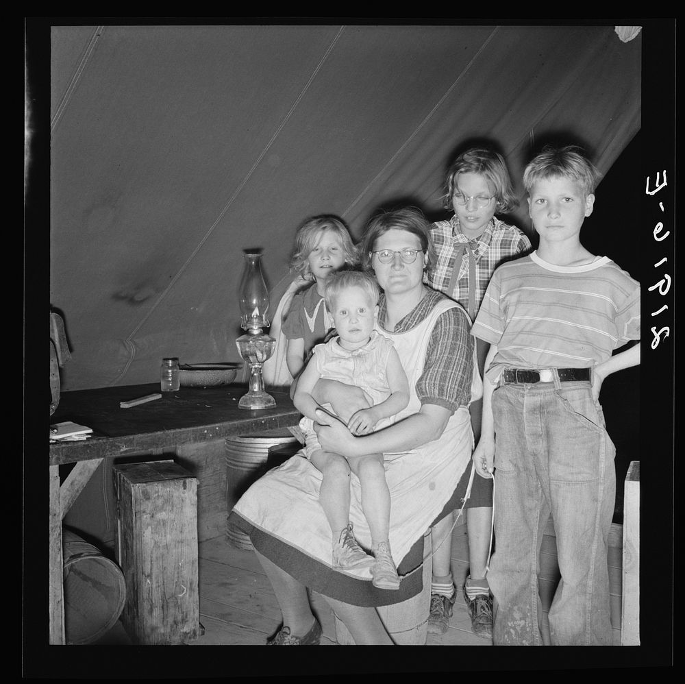 [Untitled photo, possibly related to: Family of six in tent after supper. Came to potato harvest after father was laid off…