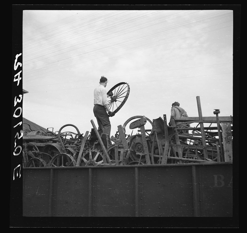 Loading scrap iron onto railroad cars. Millville, Wisconsin by Russell Lee