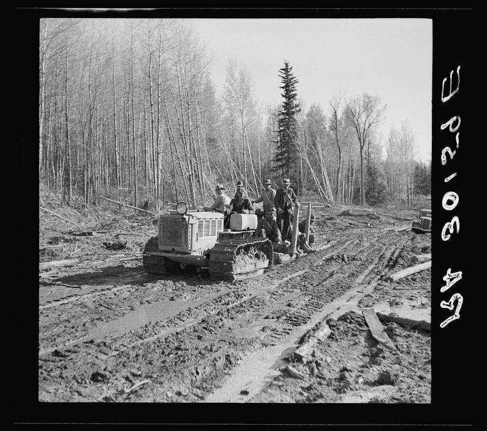 Tractor carrying men from work. Near Littlefork, Minnesota by Russell Lee