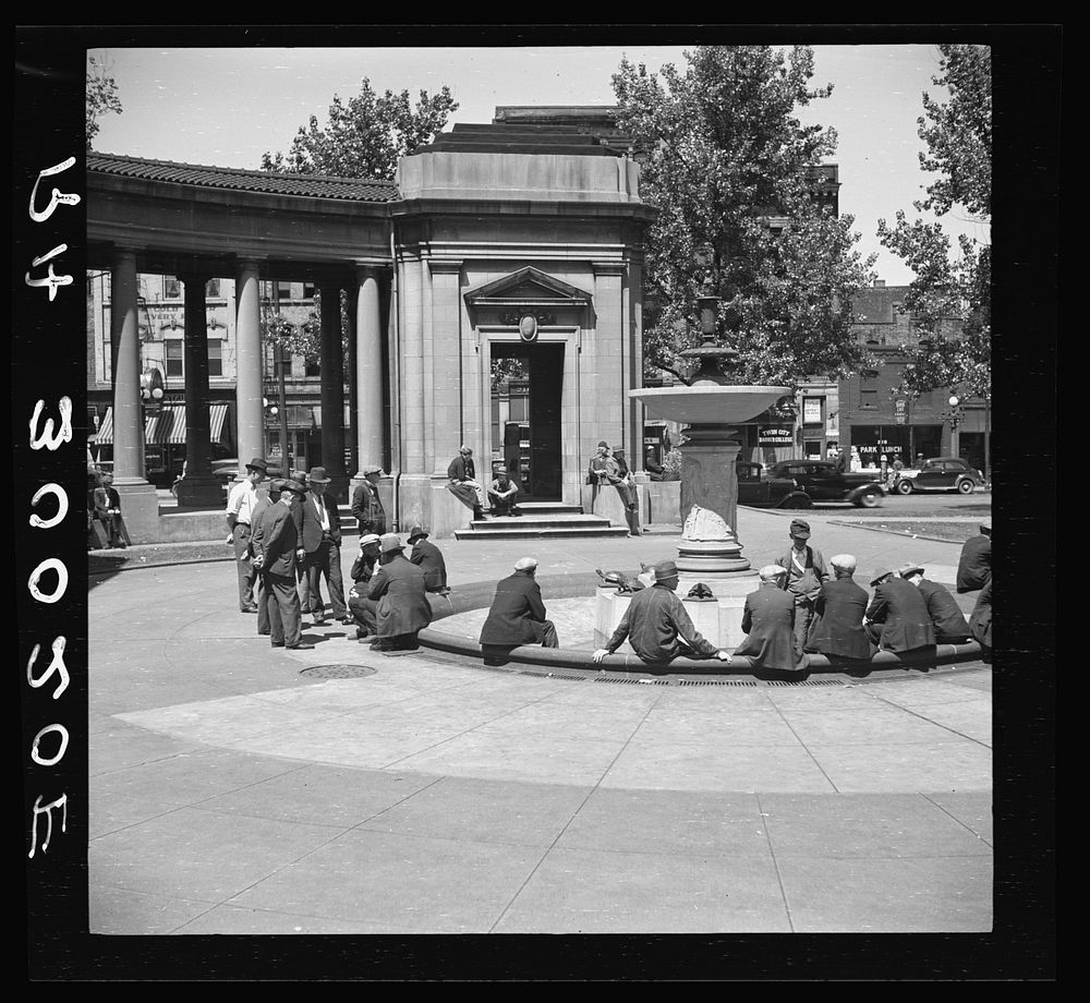 Men sitting in park square fountain. Minneapolis "Gateway" district by Russell Lee