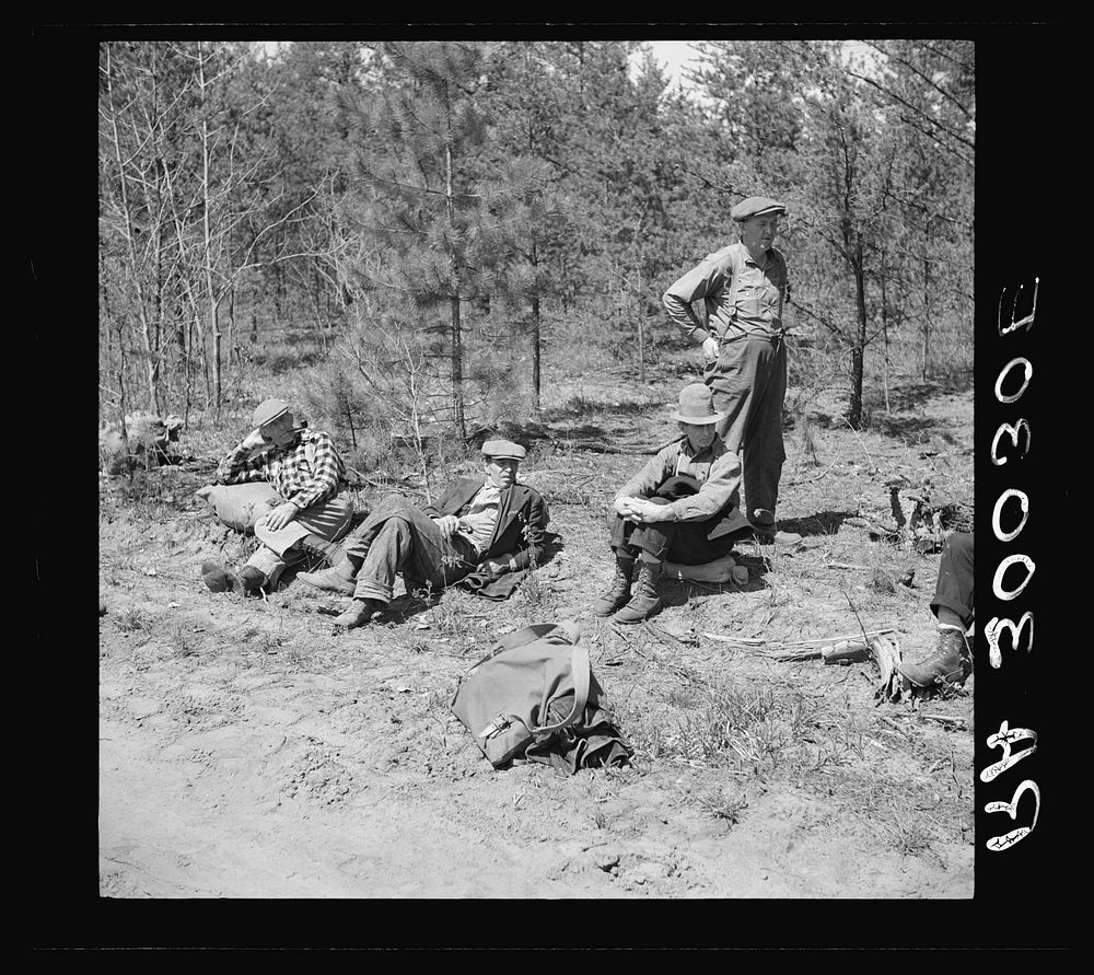 Lumberjacks resting by roadside near Littlefork, Minnesota by Russell Lee