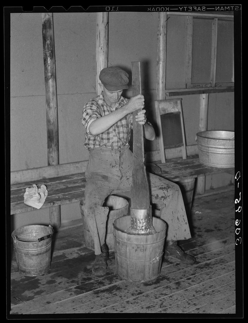 Lumberjack washing clothes at logging camp near Effie, Minnesota by Russell Lee