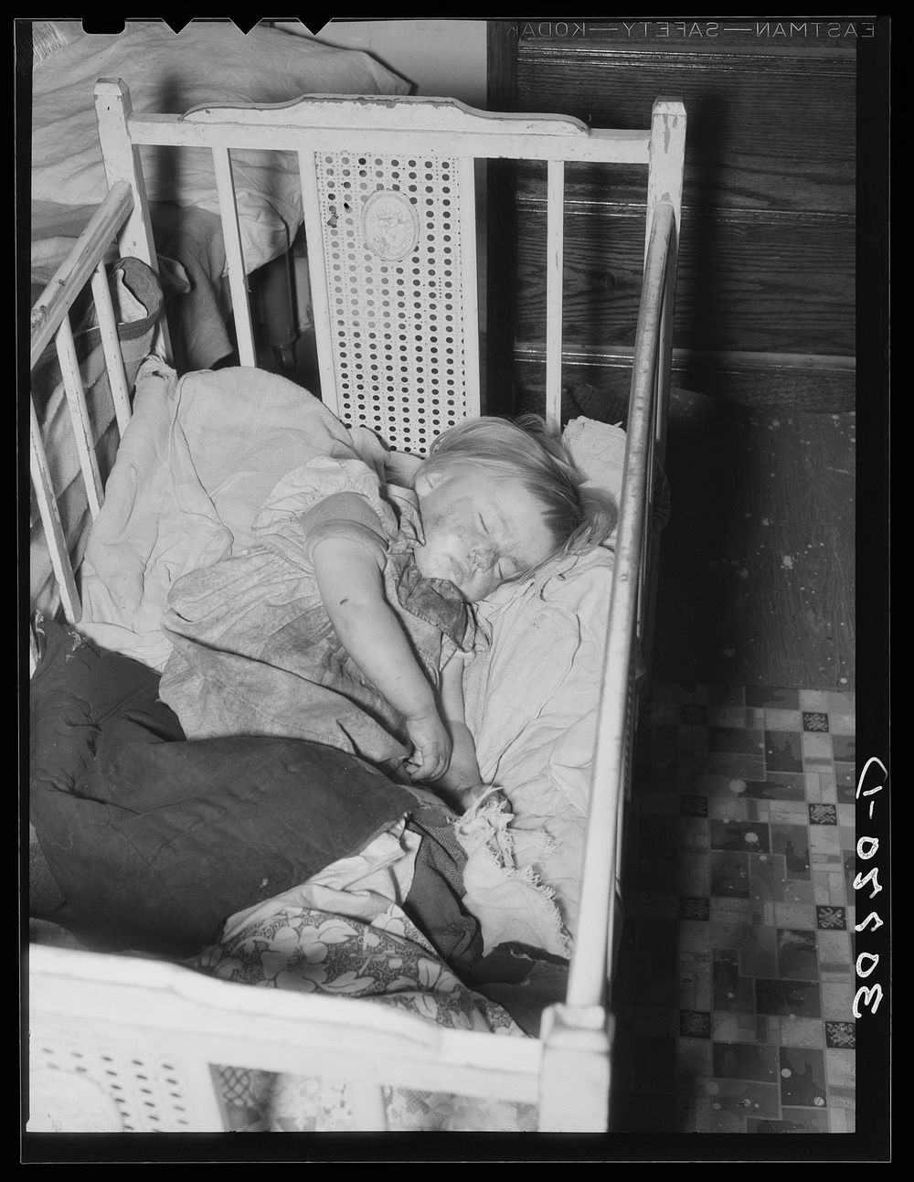 Sleeping child in farm home. Williams County, North Dakota by Russell Lee