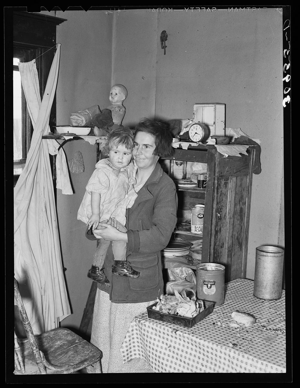 Mother and child in corner of farm home. Sheridan County, Montana by Russell Lee