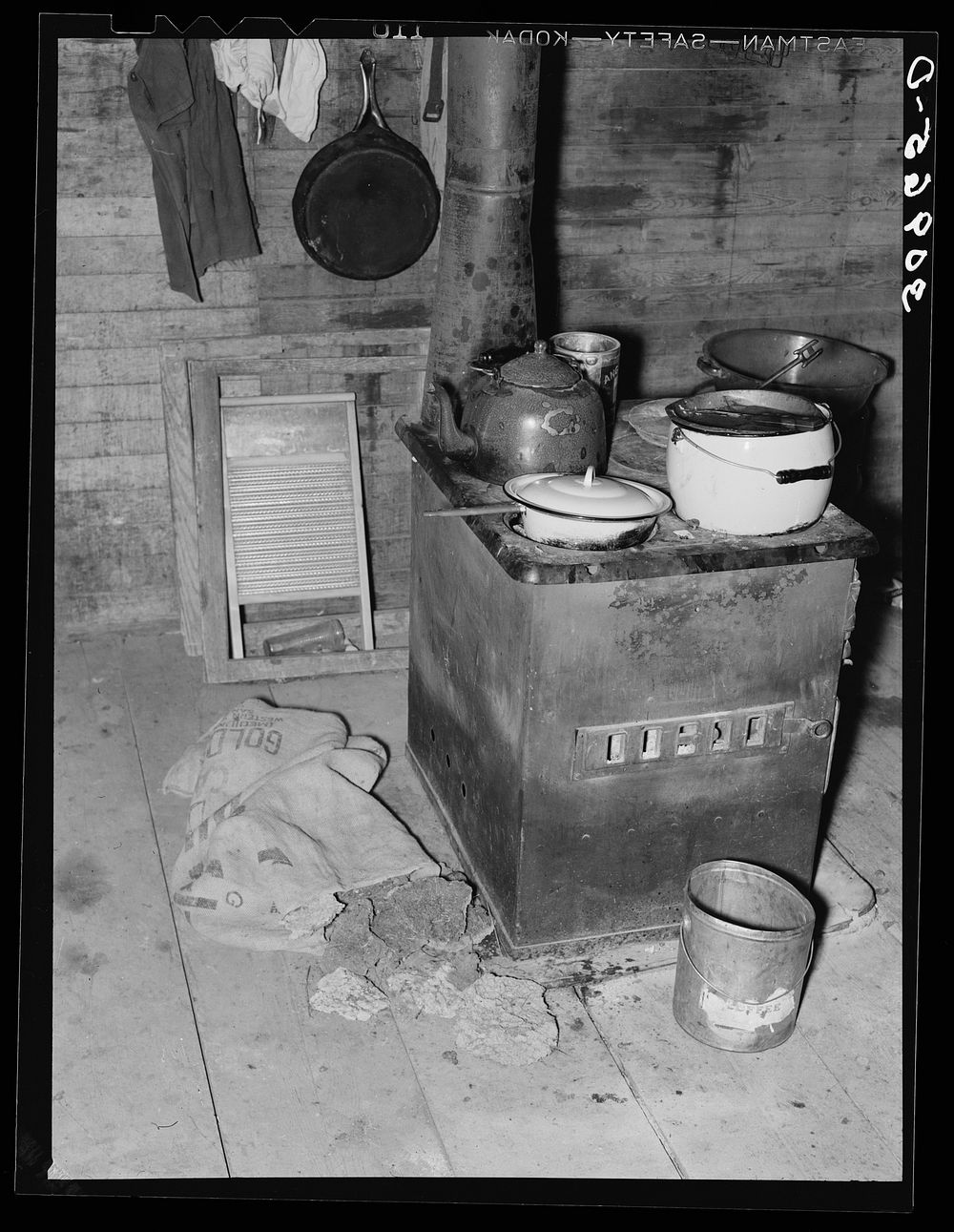 Kitchen stove and bag full of cow dung used as fuel. Sheridan County, Montana by Russell Lee