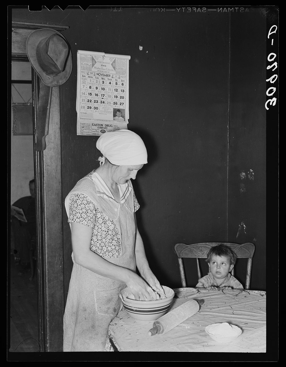 Mrs. Baker, wife of farmer, kneading dough near Ambrose, North Dakota by Russell Lee