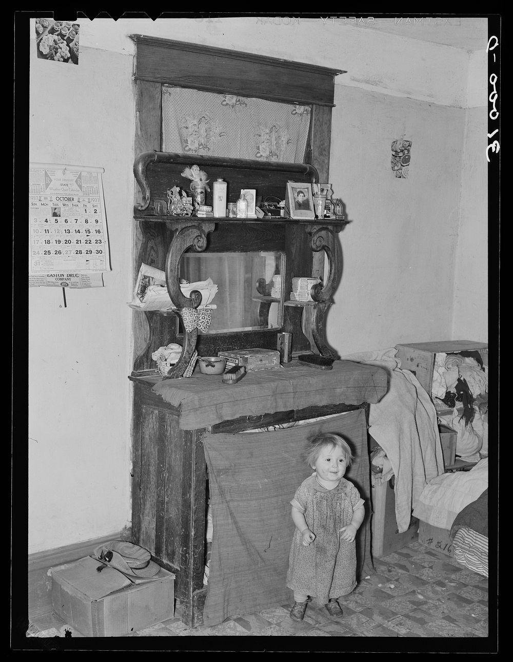 Baby in front of dresser in John Baker's farm home. Divide County, North Dakota by Russell Lee