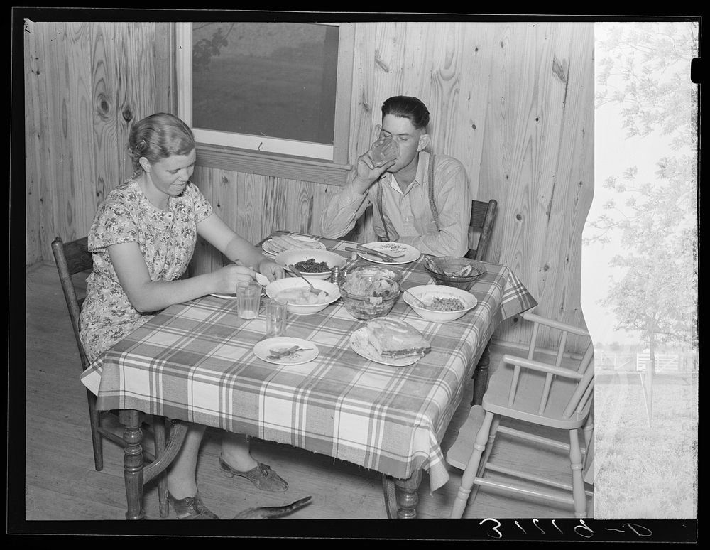 Southeast Missouri Farms. Dinner in new home of resettled sharecropper. La Forge project, Missouri by Russell Lee