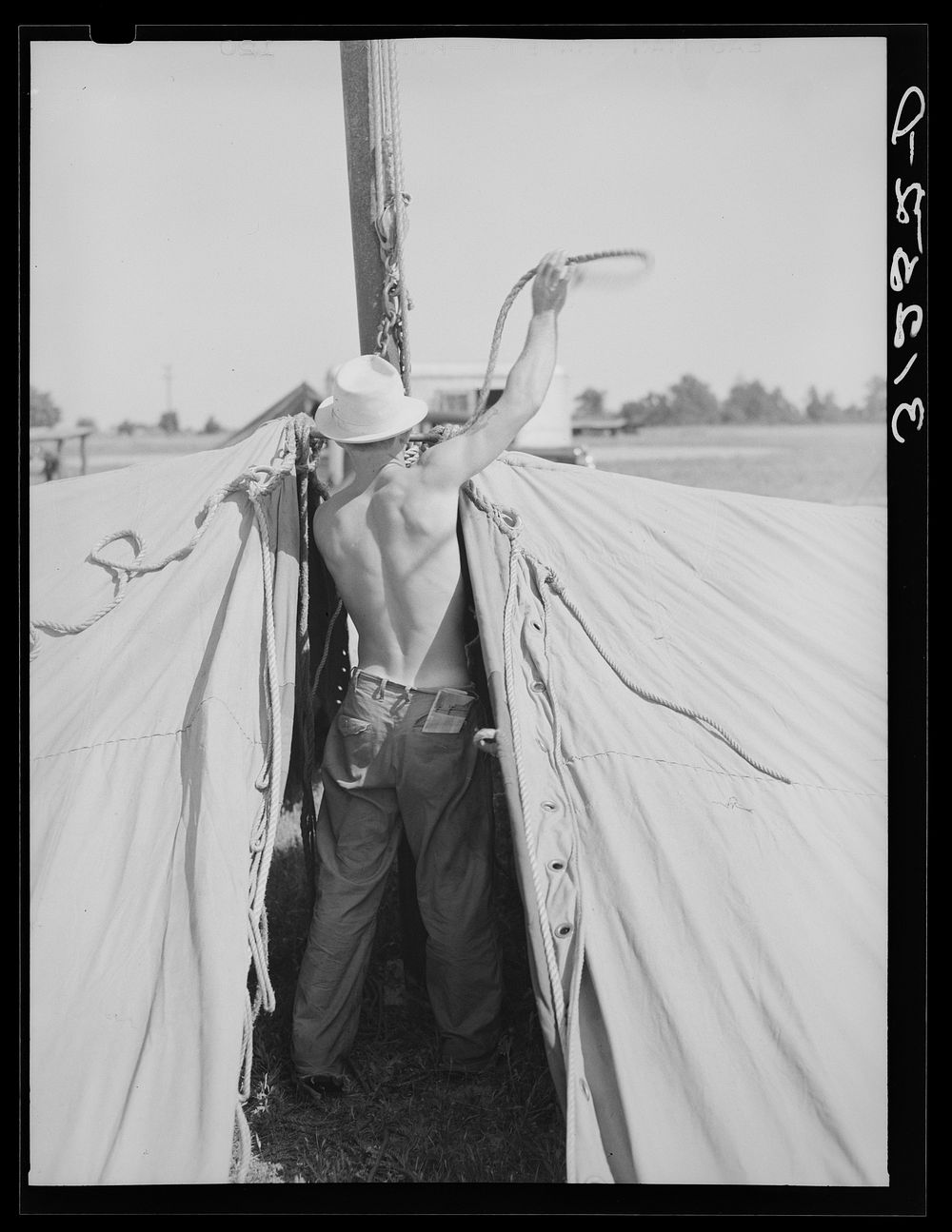 Member of carnival crew at work. Lasses-White traveling show. Sikeston, Missouri by Russell Lee