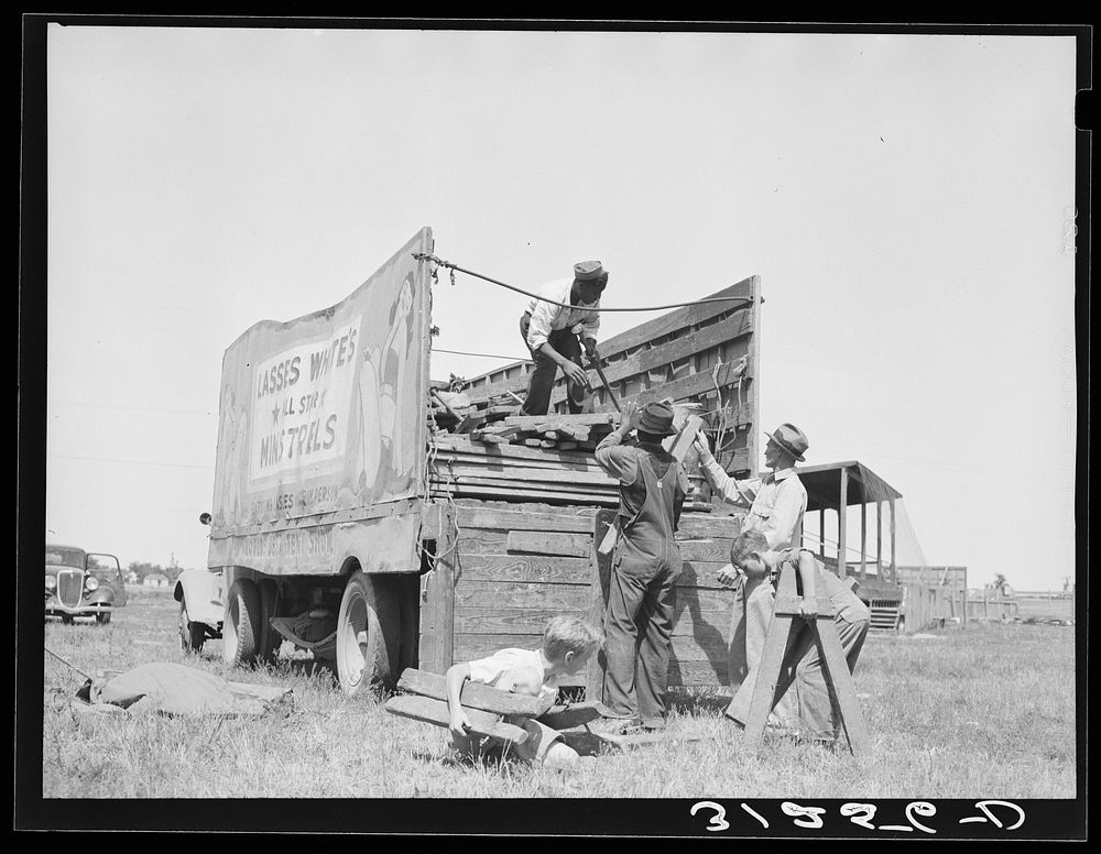 Unloading stakes and horses. Lasses-White tent show. Note local children at work. Sikeston, Missouri by Russell Lee