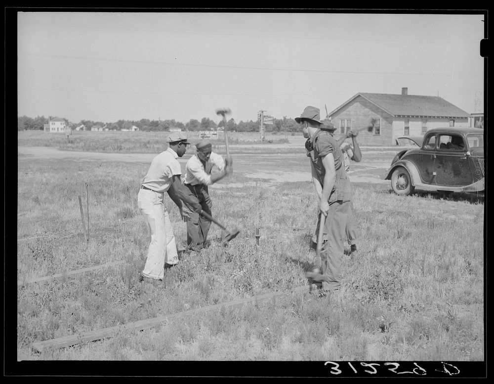 [Untitled photo, possibly related to: Driving stakes for Lasses-White show. Sikeston, Missouri] by Russell Lee