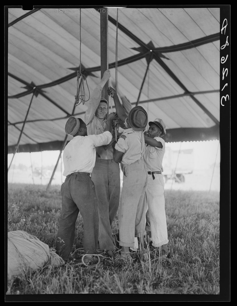 Tightening ropes in raising circus tent. Lasses-White traveling show.  Sikeston, Missouri by Russell Lee