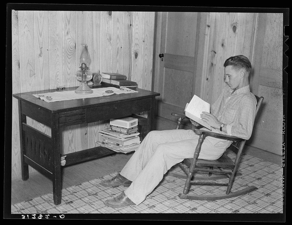 Son of Atkinson family reading at new home. Southeast Missouri Farms by Russell Lee