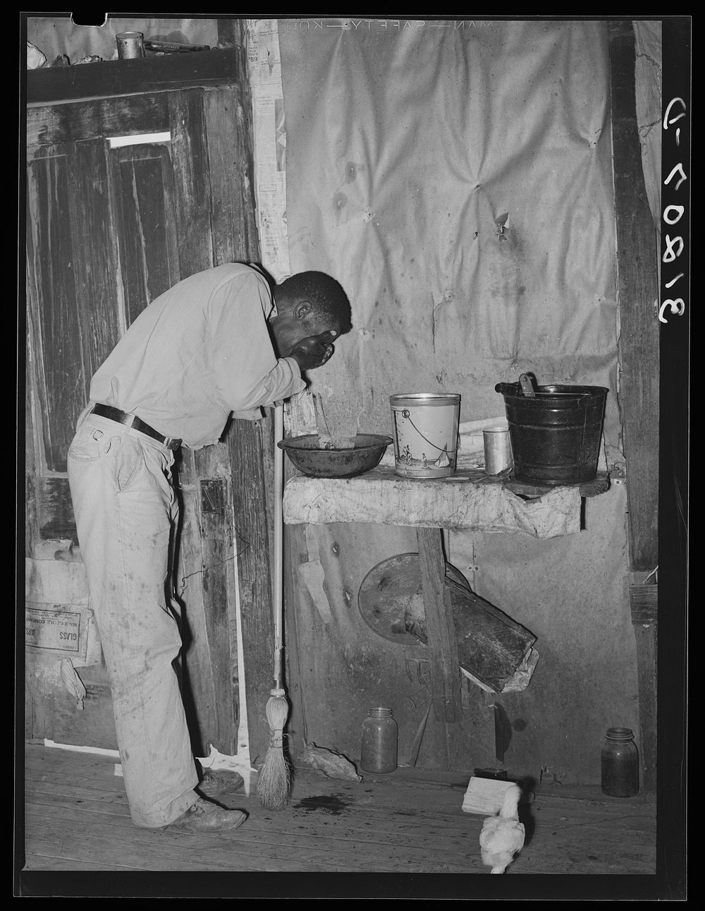 Southeast Missouri Farms. FSA (Farm Security Administration) client, former sharecropper, washing his face in former home by…