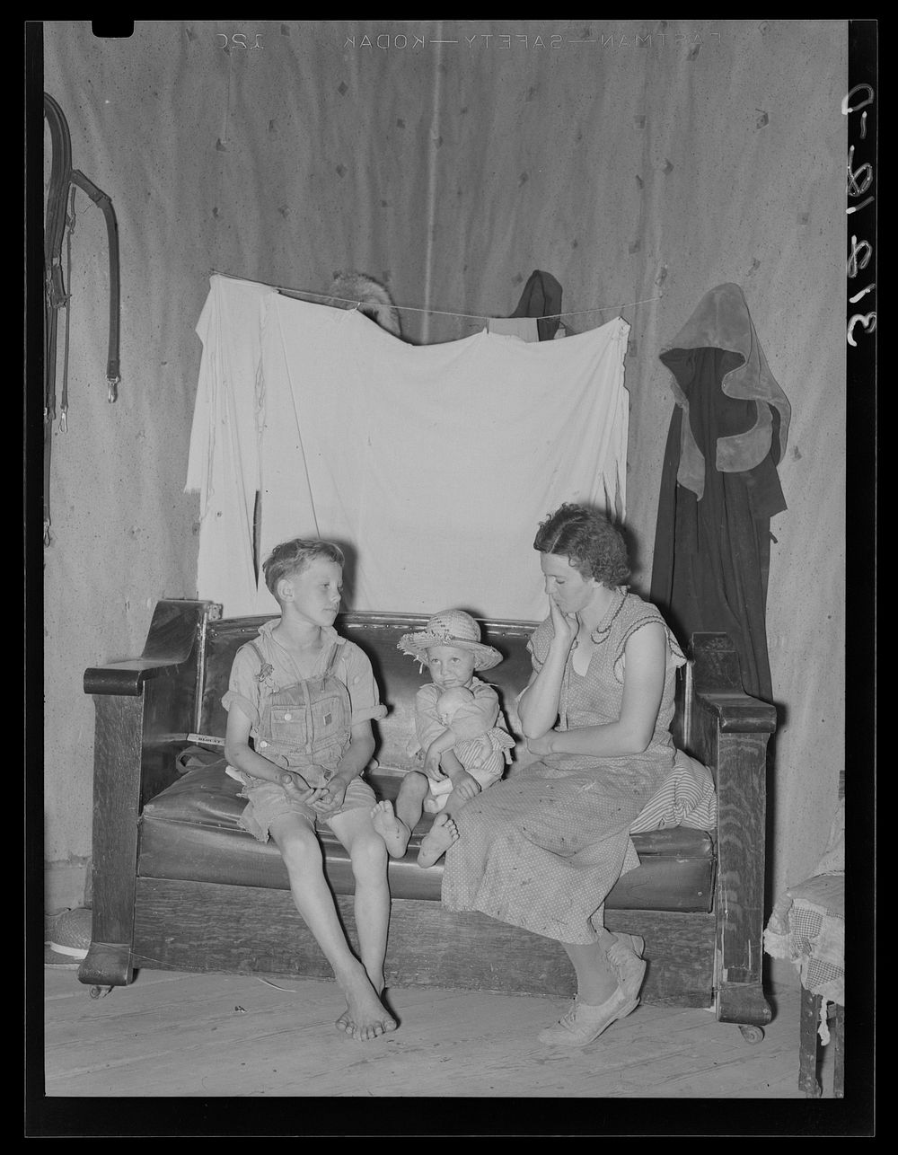 Sharecropper mother and children in corner of living room. Southeast Missouri farms by Russell Lee