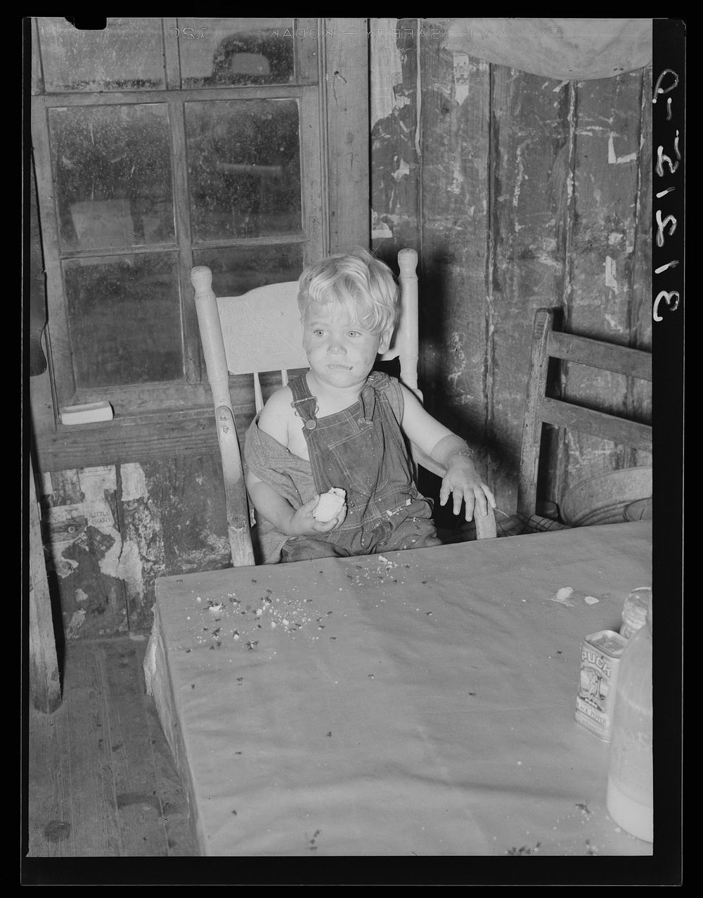 Sharecropper's child eating at table. Southeast Missouri Farms by Russell Lee