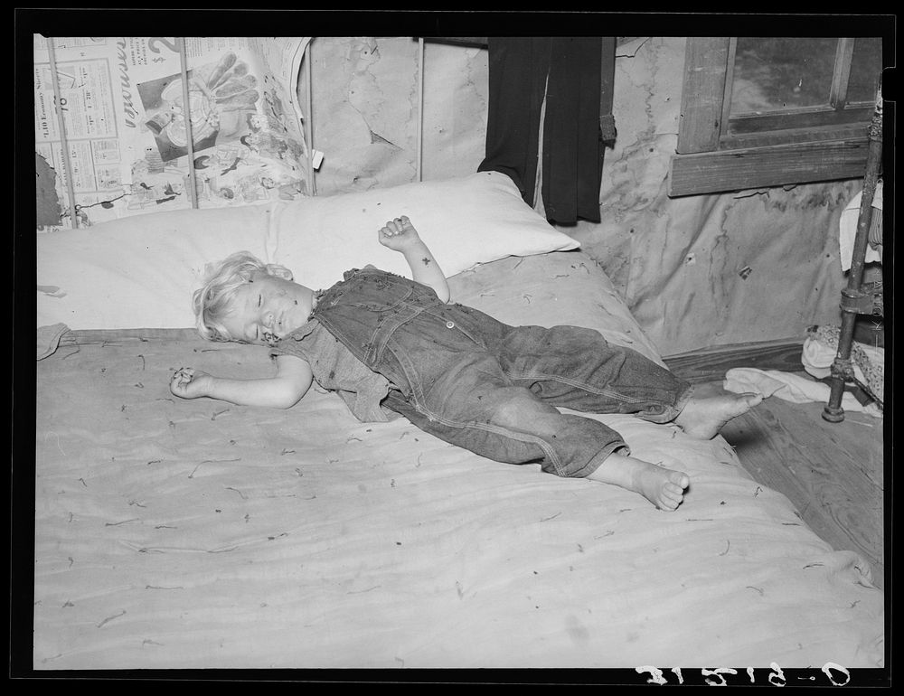 Southeast Missouri Farms. Sharecropper's child asleep on bed by Russell Lee