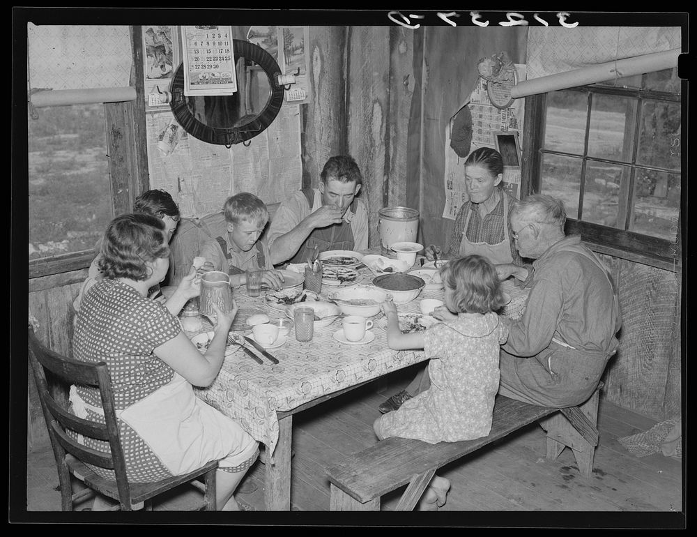 Sharecropper's family at midday meal. Southeast Missouri Farms by Russell Lee