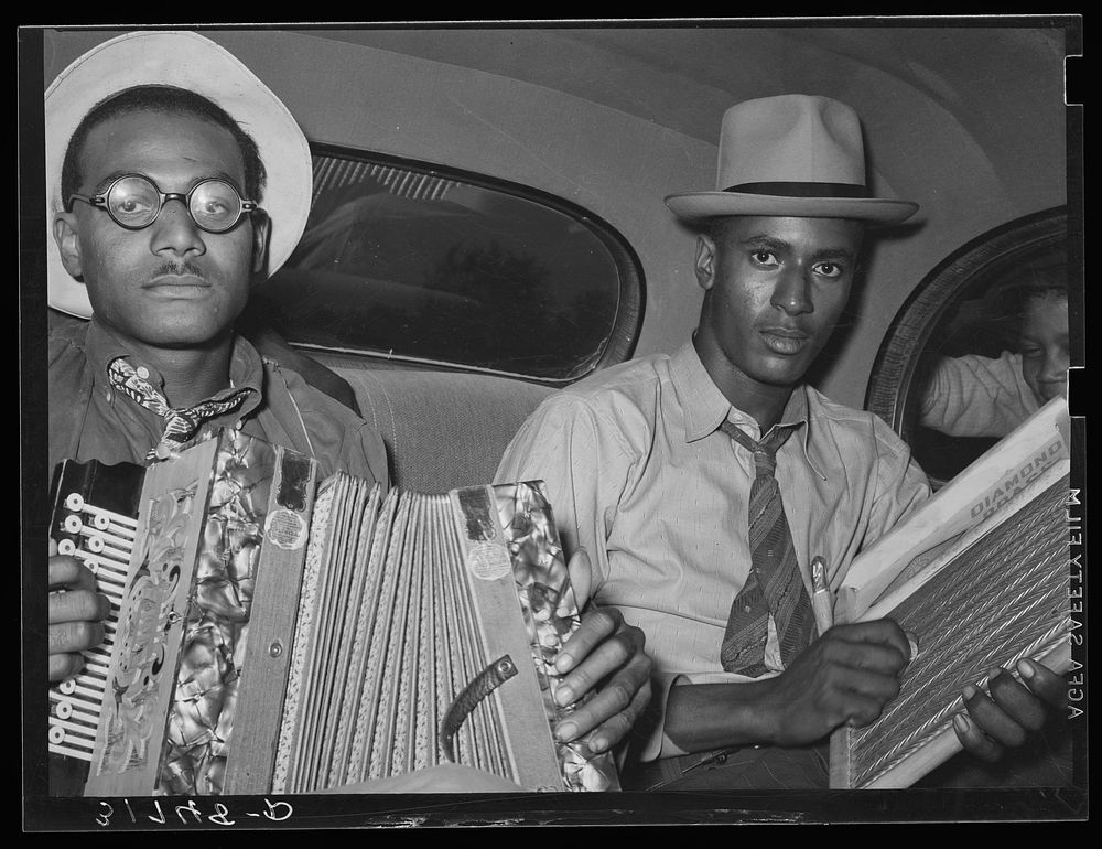 African American musicians in car playing accordion and washboard and singing. Near New Iberia, Louisiana by Russell Lee