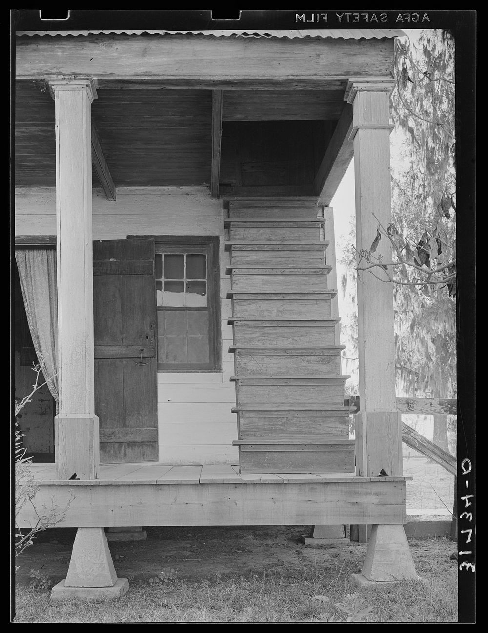 Detail of Acadian house with outside stairway leading to attic. Near Breaux Bridge, Louisiana by Russell Lee