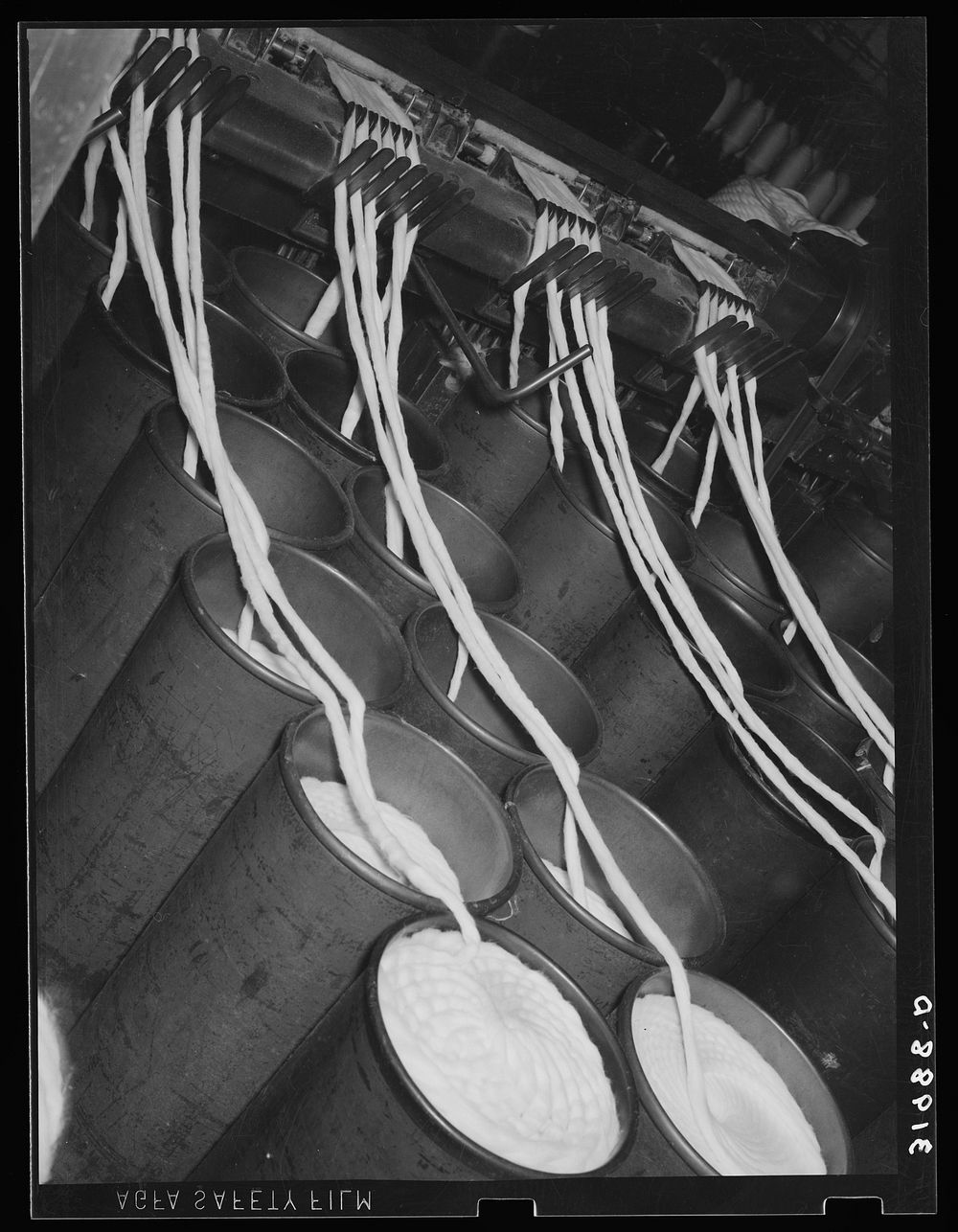 Bin of cotton rope being fed into thread-making machine. Laurel cotton mills, Laurel, Mississippi by Russell Lee