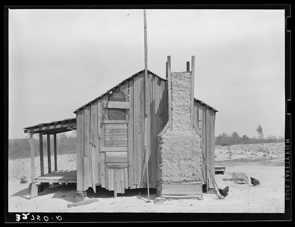 Home of tenant farmer with mud and straw chimney. Near Marshall, Texas by Russell Lee