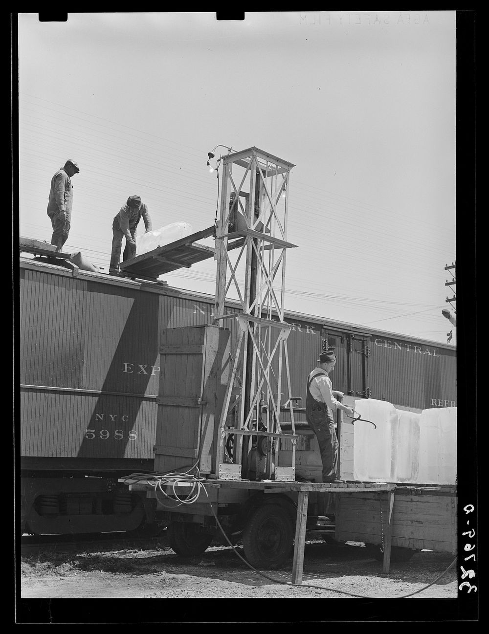 Icing refrigerator cars for shipment of strawberries. Hammond, Louisiana by Russell Lee
