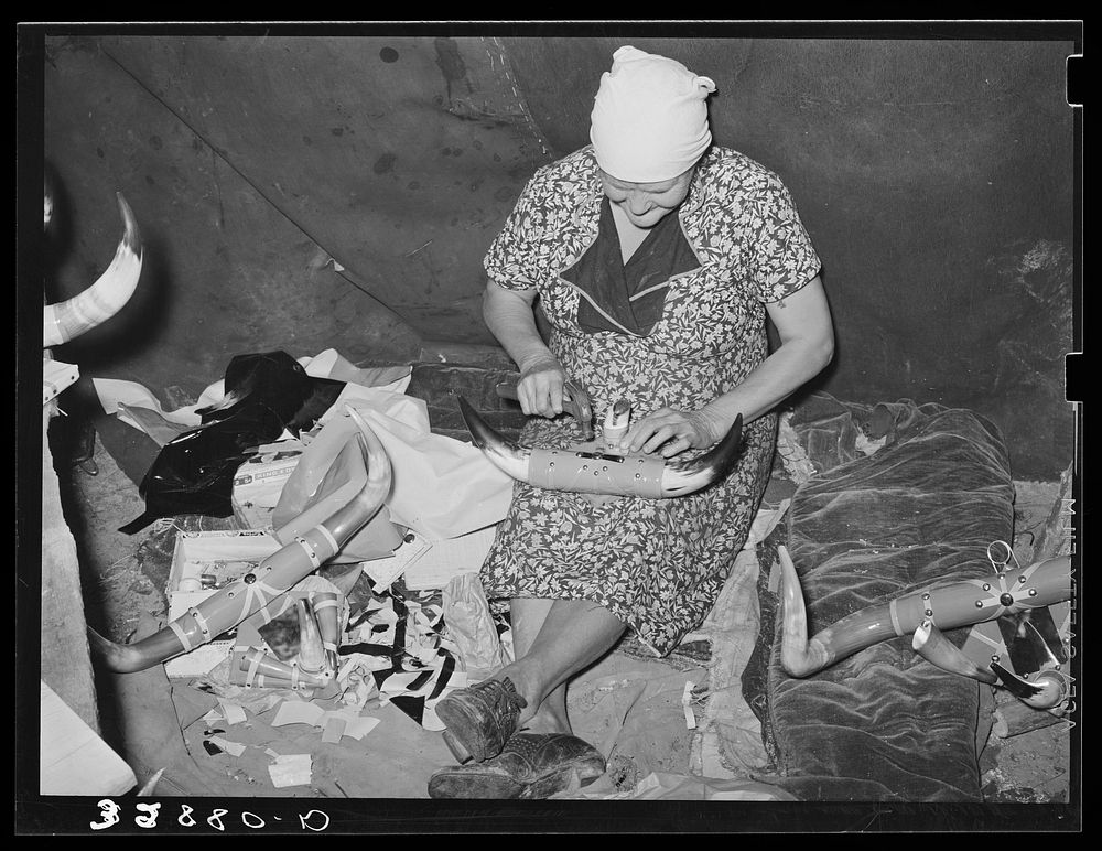 White migrant woman finishing an ornament made of horns. They depend upon the sale of these ornaments for a living. Hammond…