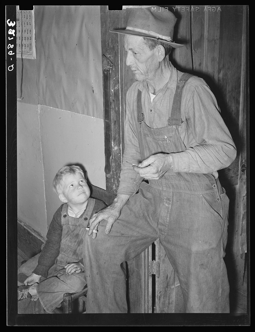 Ex-farmer and his son now living on relief. Outskirts of Jefferson, Texas by Russell Lee