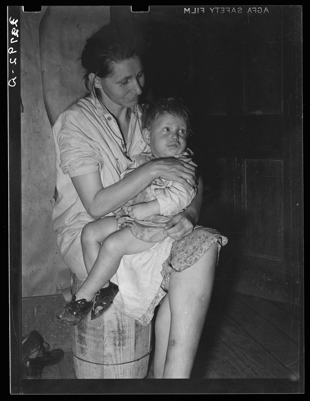 Mother and child. This woman, wife of an ex-farmer now living on relief, had pellagra in an advanced stage. She has had some…