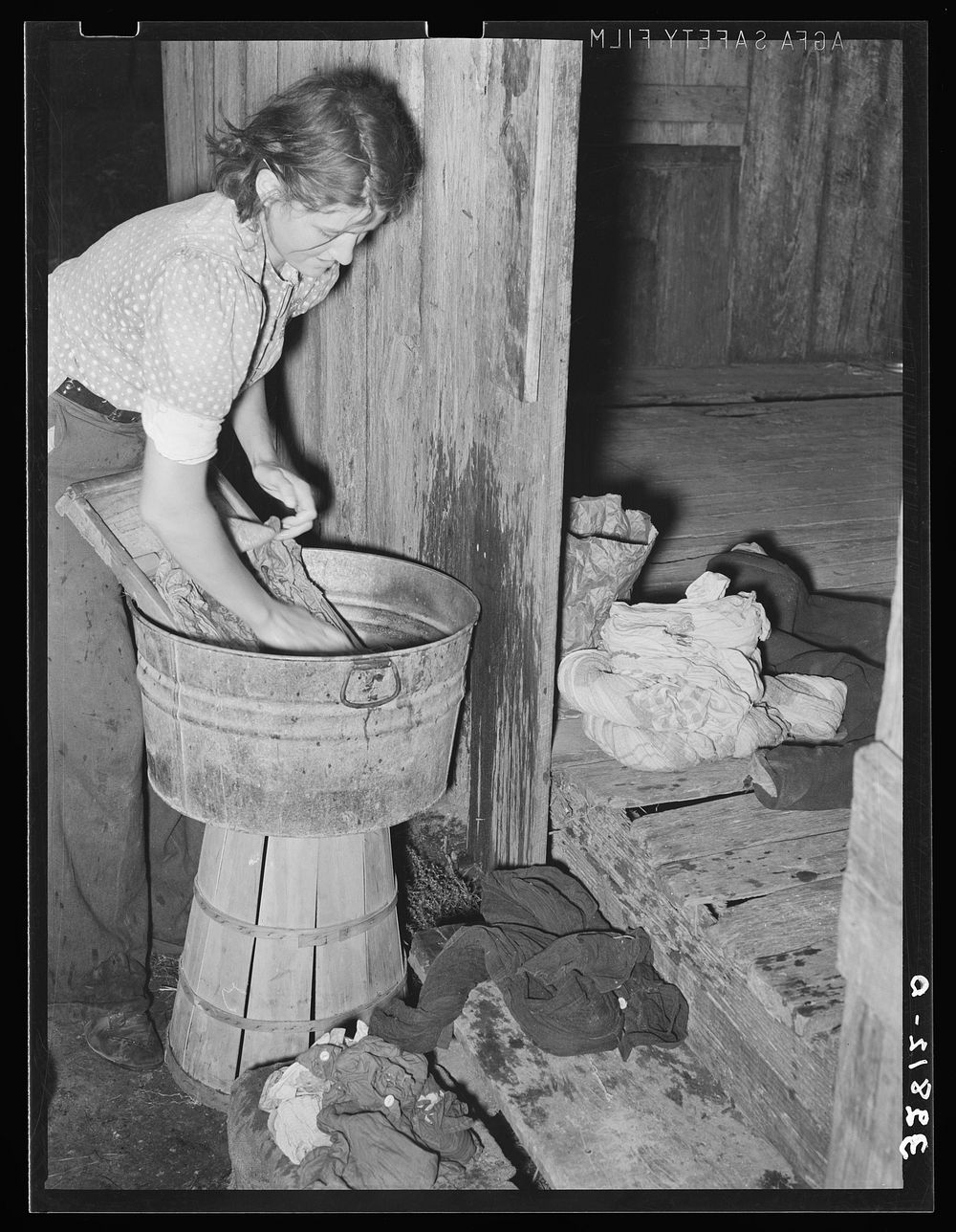 White woman, migratory berry picker, doing the laundry near Ponchatoula, Louisiana by Russell Lee
