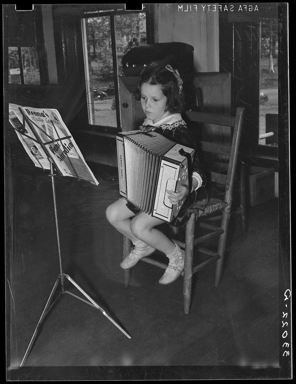Young accordian player. Grade school, San Augustine, Texas by Russell Lee