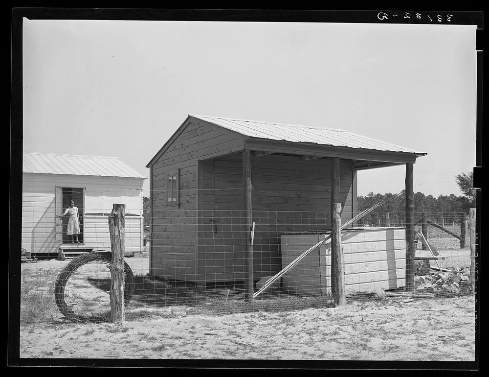 Shed and corner of house on farm unit. Sabine Farms, Marshall, Texas by Russell Lee