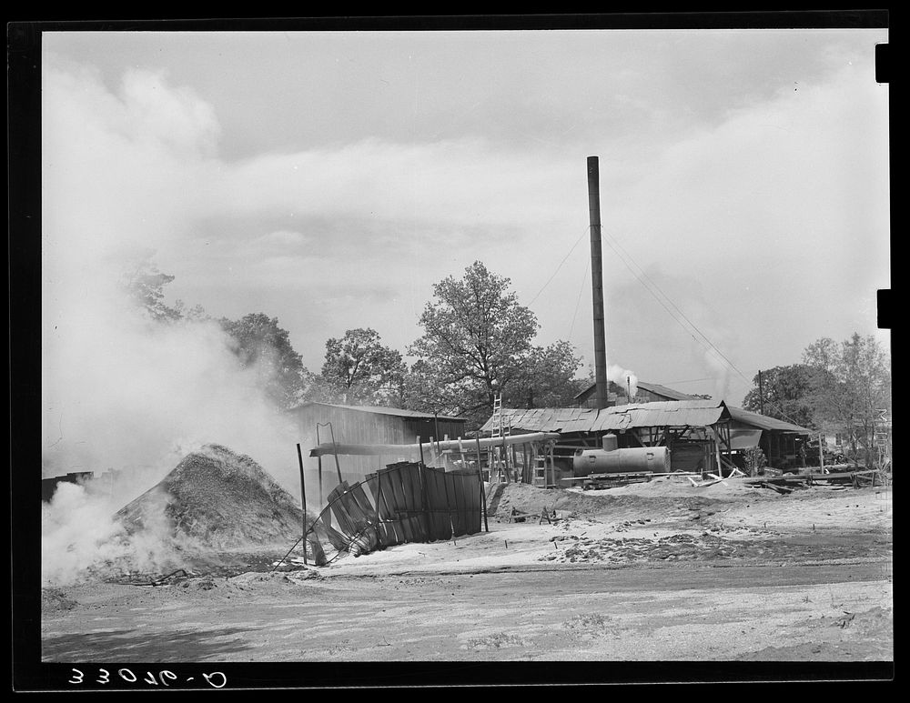 Burning pile of sawdust at sawmill at Wells, Texas by Russell Lee