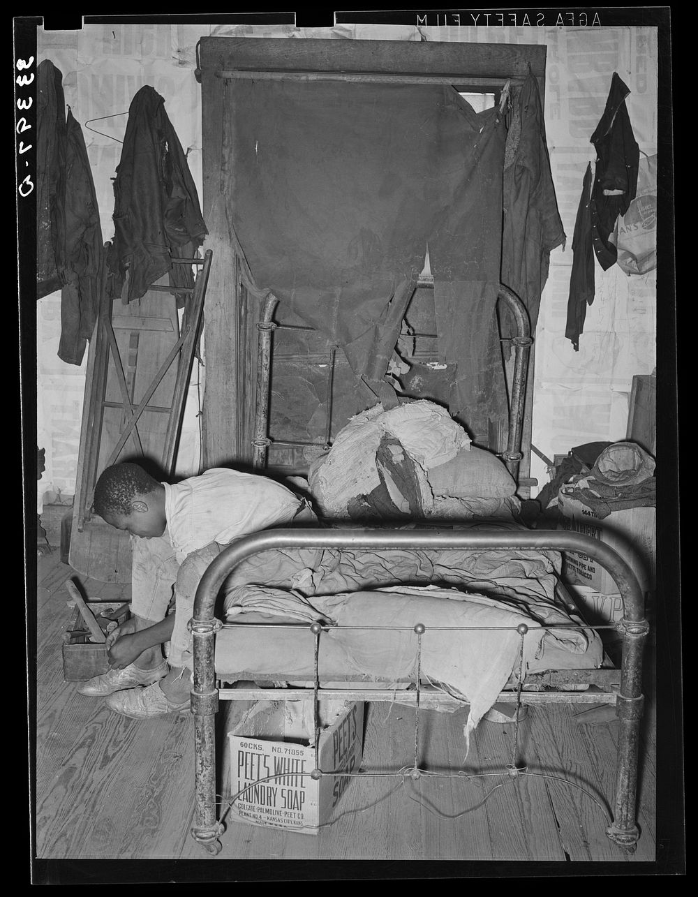 [Untitled photo, possibly related to:  agricultural day laborer putting on his shoes. Muskogee, Muskogee County, Oklahoma]…