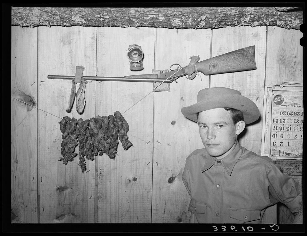 Son of agricultural day laborer with his twenty-two caliber rifle and home-cured tobacco. McIntosh County, Oklahoma by…