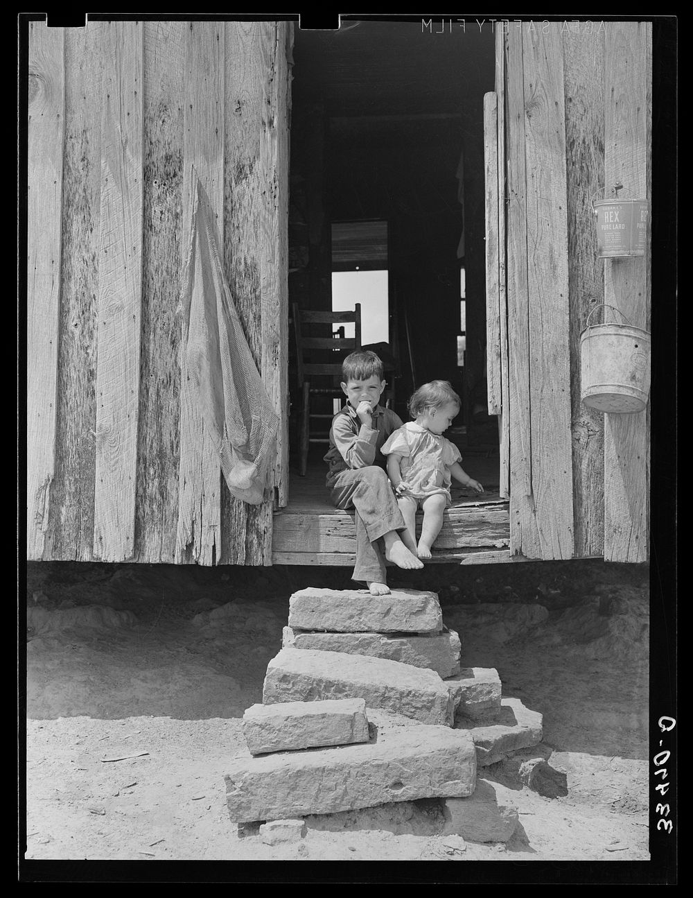 Children of tenant farmer on back steps of house near Warner, Oklahoma by Russell Lee