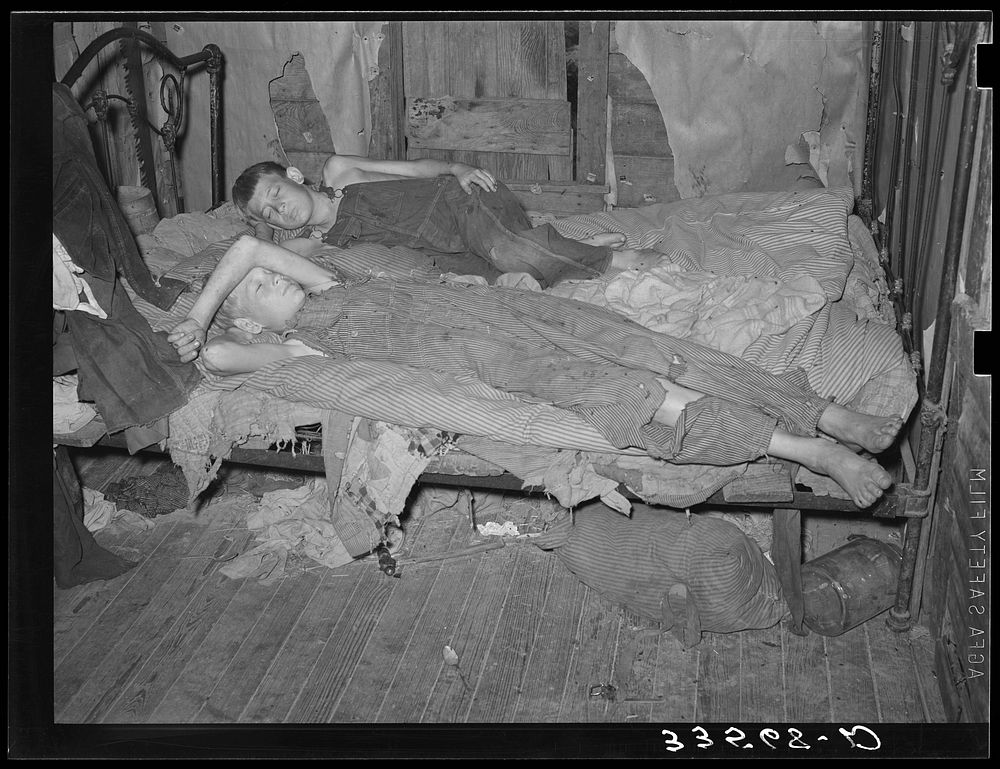 Sons of agricultural day laborer taking a nap. McIntosh County, Oklahoma by Russell Lee