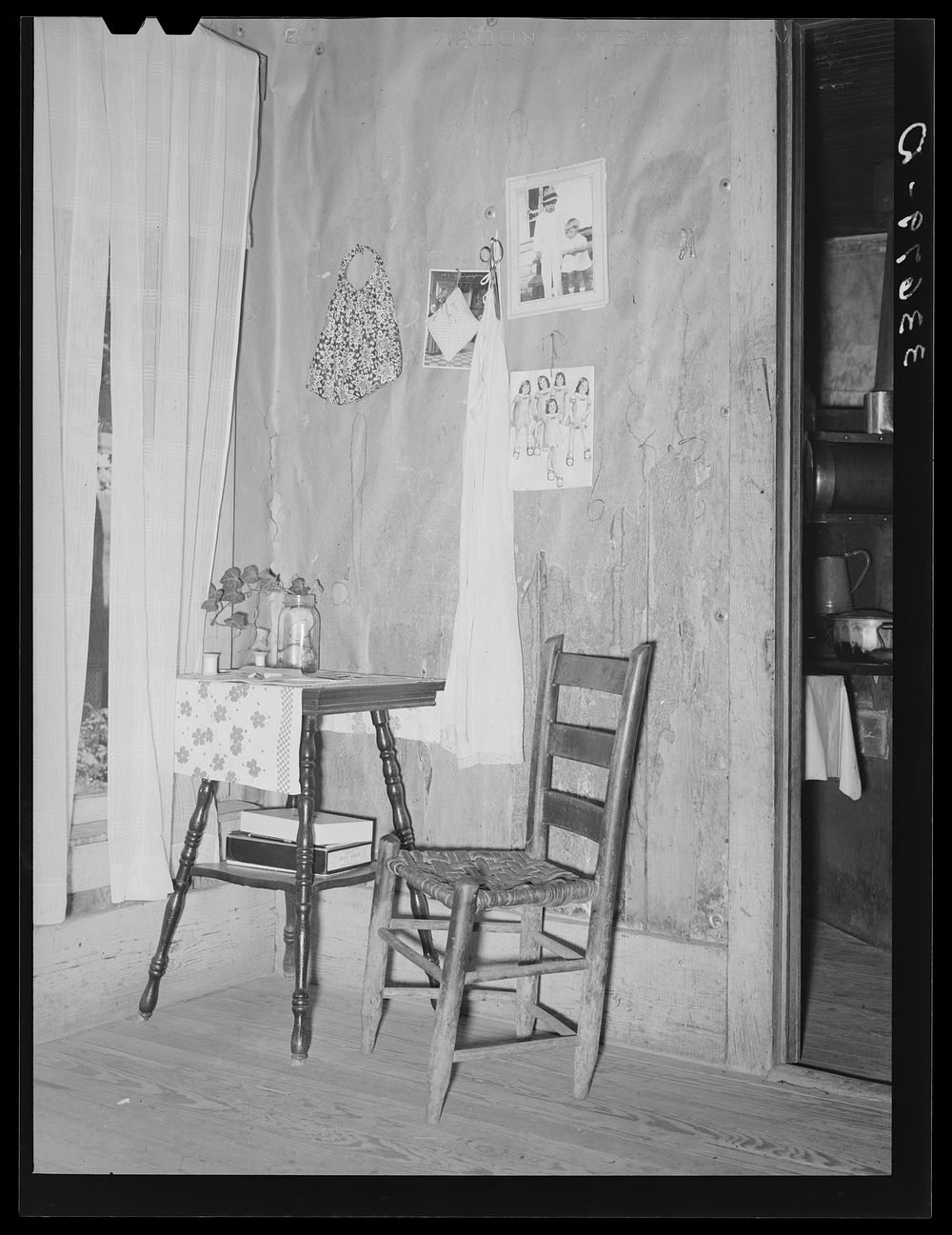 Corner of living room of farm family now on WPA (Works Progress Administration/Work Projects Administration) road work. Near…