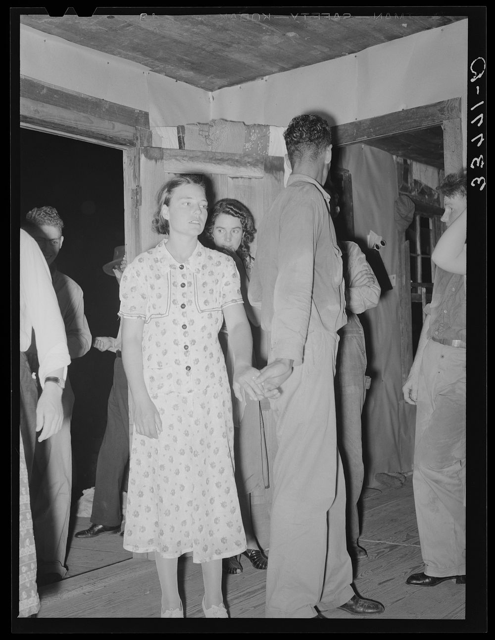 Young couple at square dance in rural section of hills near McAlester, Pittsburg County, Oklahoma. Sharecropper's home by…