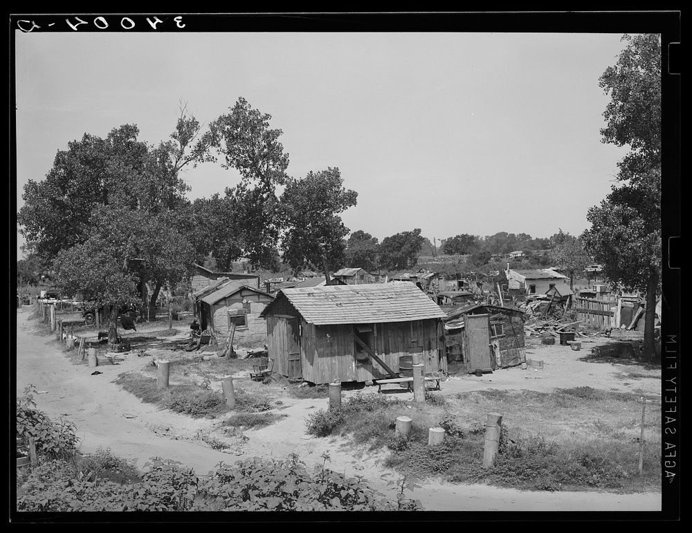 Part of Mays Avenue camp. Oklahoma City, Oklahoma. Notice water boilers which form decoration and fence. See general caption…