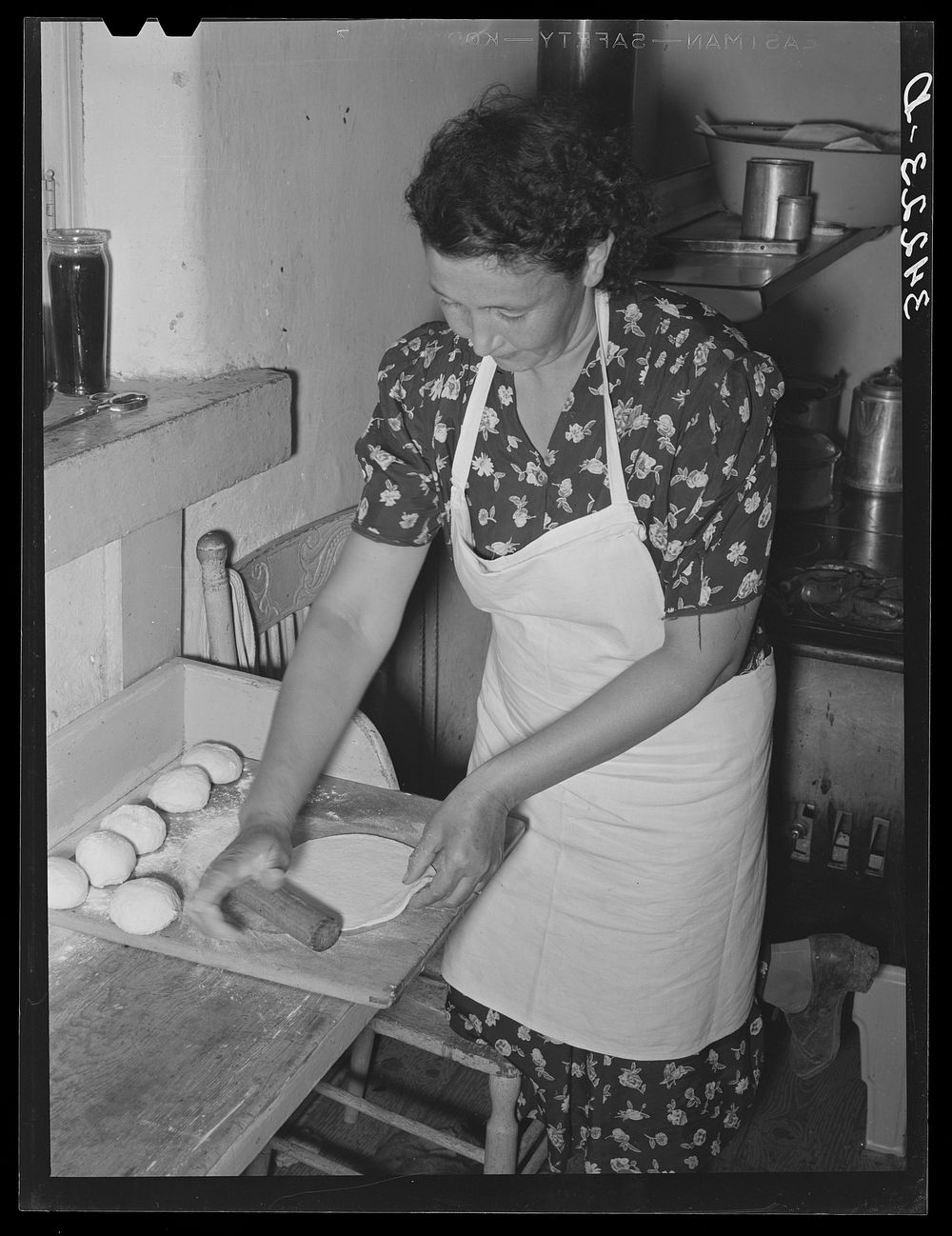 Spanish-American woman rolling out tortillas near Taos, New Mexico. Taos County by Russell Lee