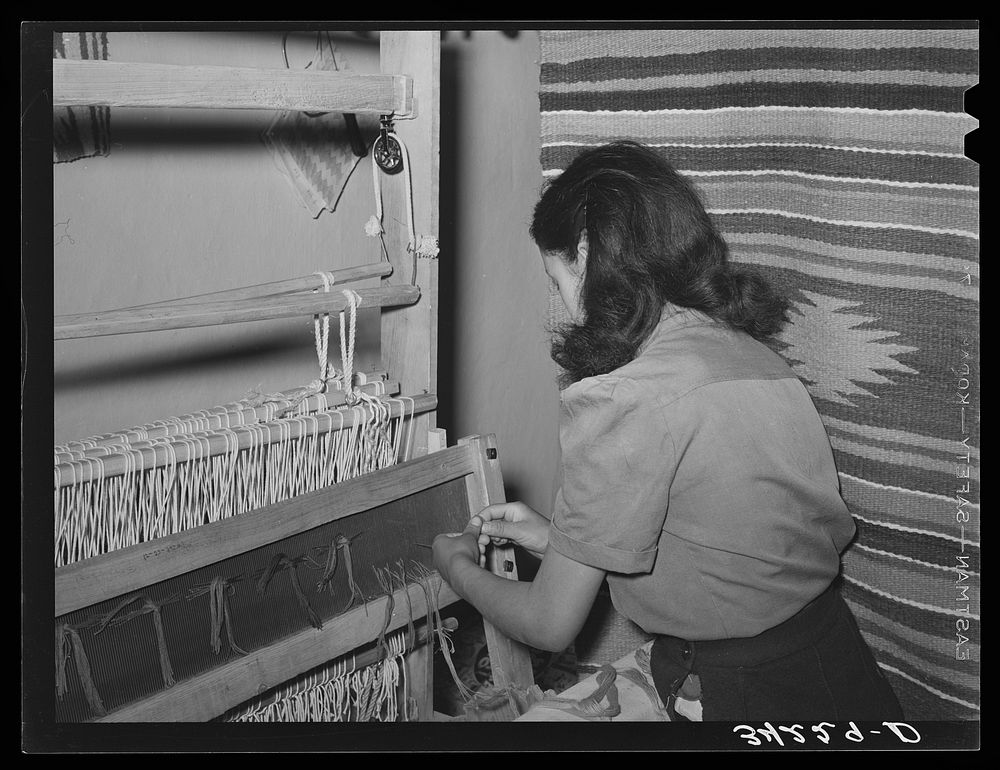 Spanish-American girl threading the loom at WPA (Works Progress Administration/Work Projects Administration) weaving…