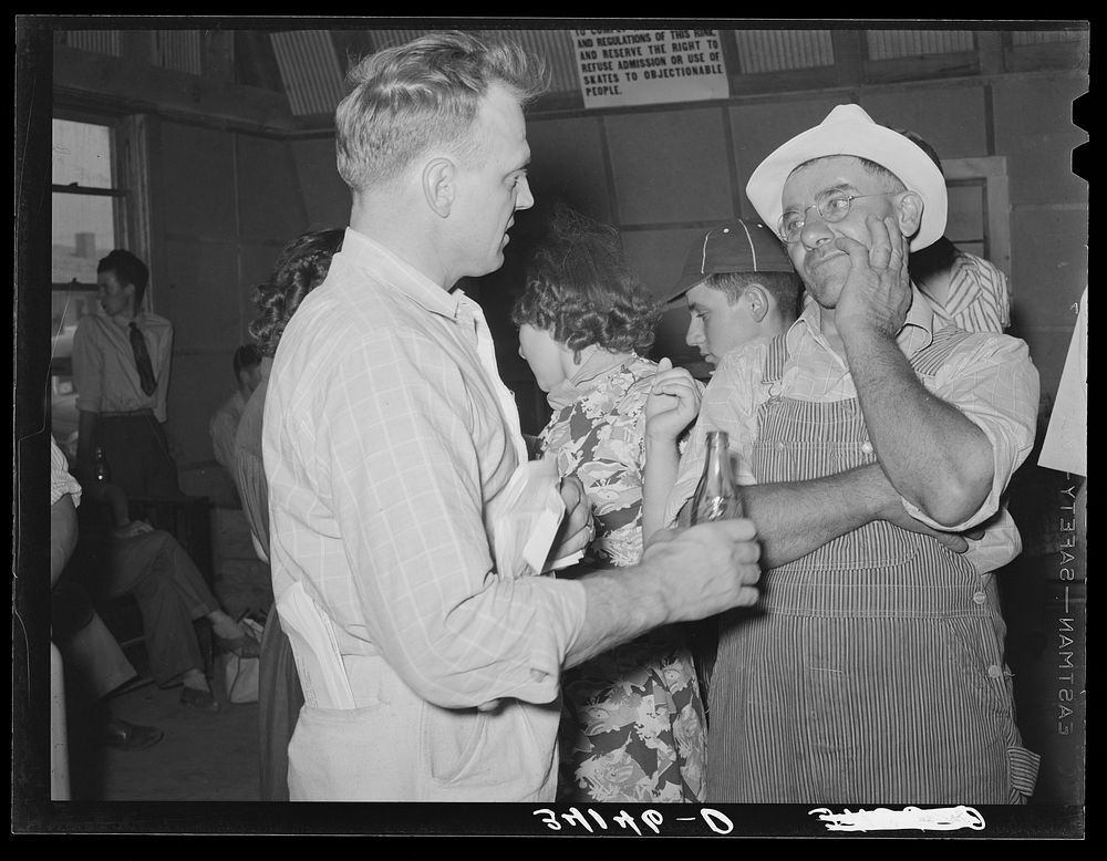 County agent. Sublette, Kansas. Talking with farmer at 4-H fair held there. These 4-H fairs have supplanted the county fair…